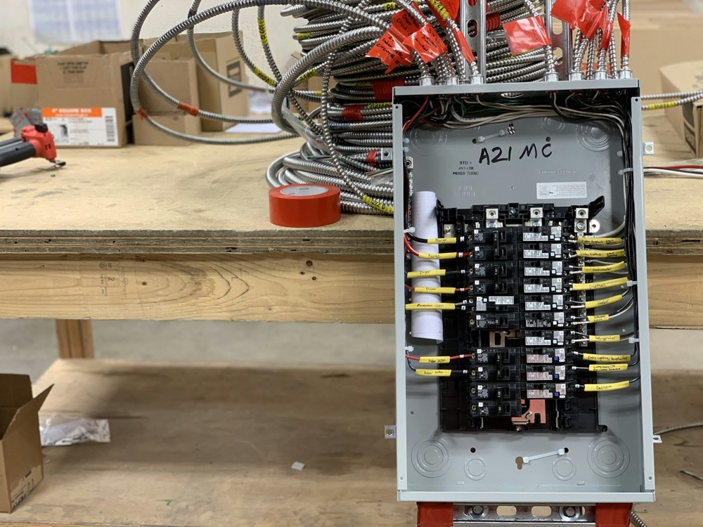 Licensed electrician installing a new residential breaker panel